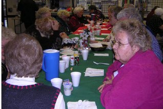 A long table of members enjoying the holiday meal