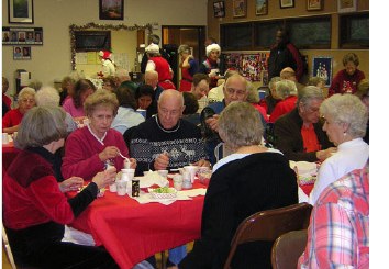 A crowded hall of friends sharing dinner together
